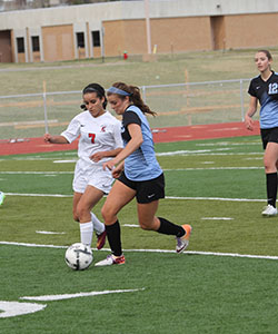 Junior Ashton Horsely dribbles the ball in the game against the Lady Indians on Friday, April 10. The Lady Thunderbirds lost the game with a final score of 2-1.
