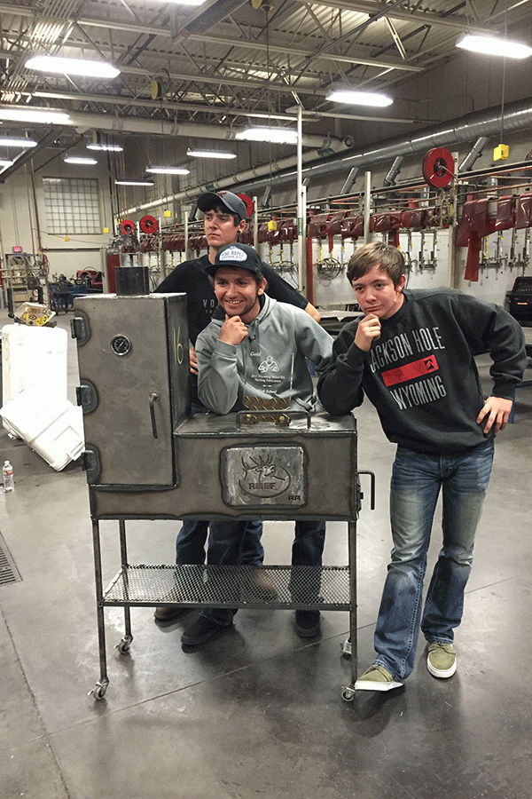Zakk Keller, Dax Cathcart and Oakley Cathcart show off their state champion welding project. The BBQ will be donated to the Rocky Mountain Elk Foundation.