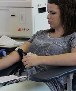 Senior Brandi Hill donates a unit of blood at the blood drive on Tuesday, April 14, 2015. EHS donated a total of 31 units of blood.