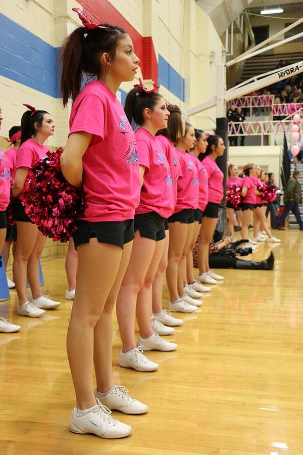 The Varsity cheer team stand at attention.