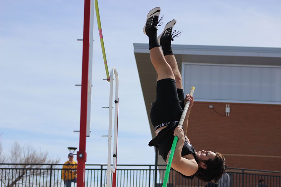 Junior Terrance Tatigue goes vertical in an attempt to clear one of the greater heights in the pole vault at the Okie Blanchard Meet.