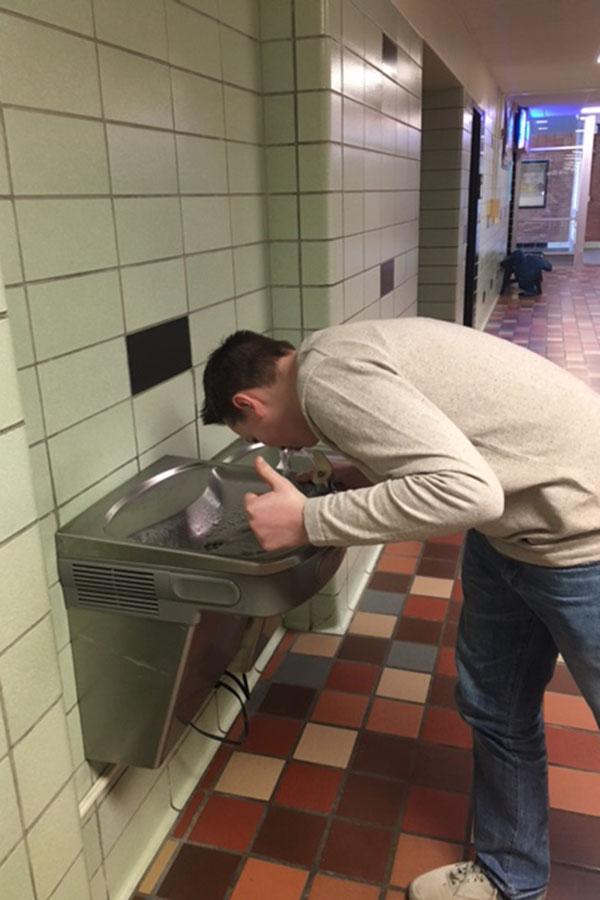 Sophomore Camden Schmidt drinks out of the number 1 ranked water fountain in East, the Tbird Nest Hallway Fountain.