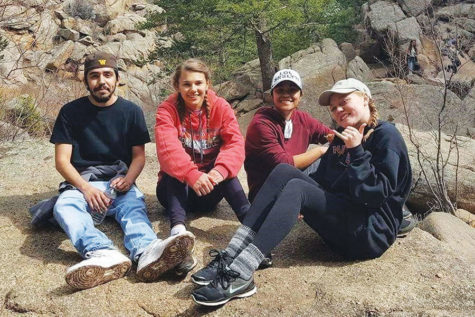 Junior Brittany West takes a break with some from friends while hiking.