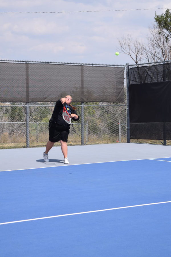 Senior Delaney Schmidt swings at a tennis tournament in early September in preparation for the State Competition. 