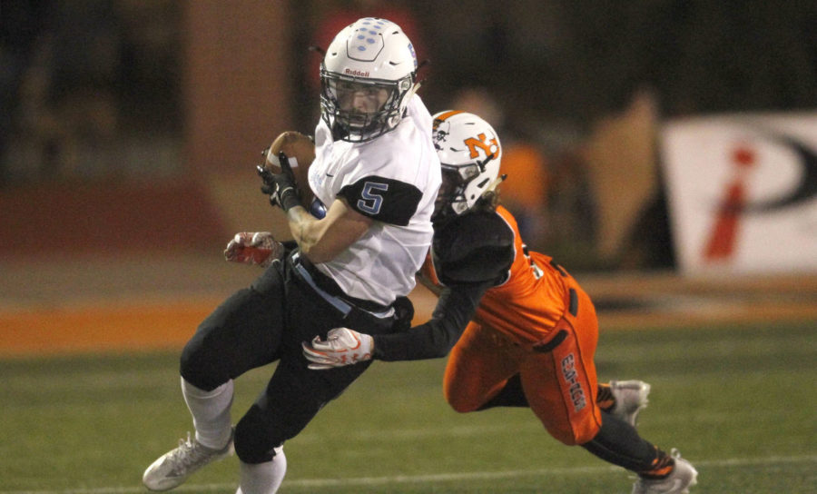 Senior Vance Nagy attempts to outrun a Natrona County Mustang during the semi final playoff game on November 3.