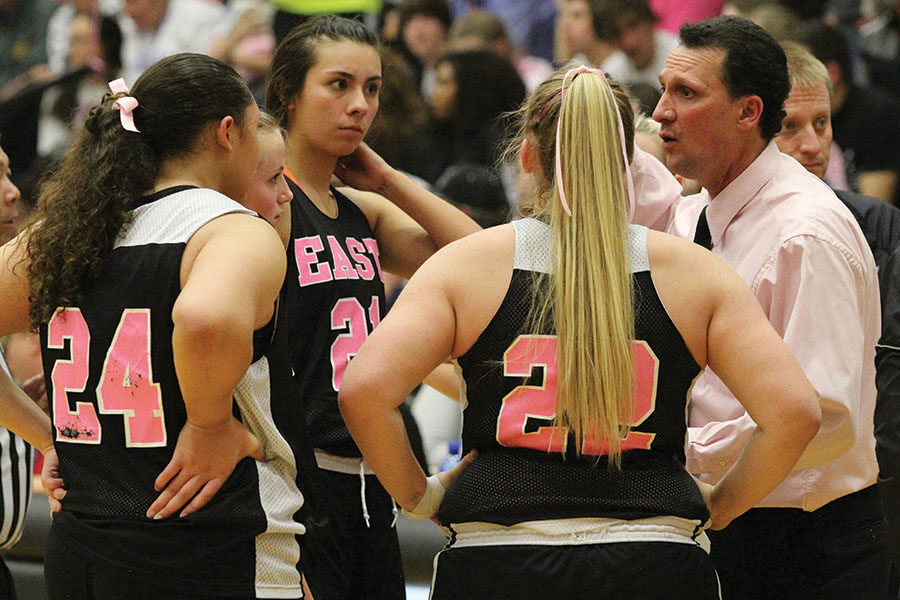 East High Varsity girls basketball players meet with Coach Horsley at the Pink Game.