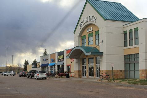 Customers patiently wait in their cars for curbside food service from Dickey’s BBQ at Frontier Mall. While some businesses with outside access remained open, the mall closed in mid-March to discourage people gathering in confined areas.