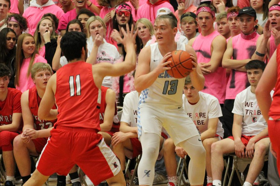 Surrounded by a sea of red, junior Graedyn Buell looks to pass inside during the Pink Game from earlier in the season. The Thunderbirds knocked the highly touted Indians out of the regional tournament, denying them a shot at a state title.