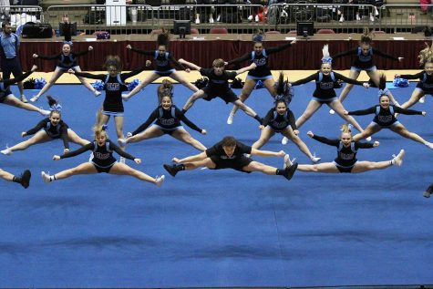 Led by senior Zak Whisenhunt, the EHS cheer team does a group jump during their Co-Ed routine at the WHSAA State Spirit competition. The T-Birds placed third.