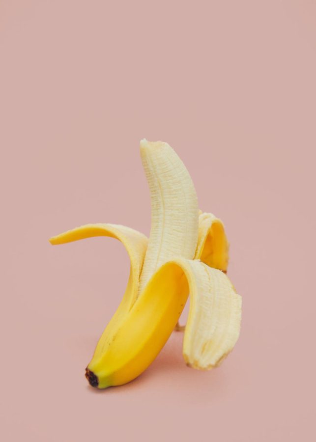 Banana+photographed+in+front+of+pink+background.+Labelled+for+common+use+via+Unsplash.