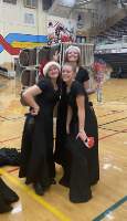 Emily Schwaiger, 12, Lana Novotny, 12, and Ella Neider, 12, group together for a photo during their last winter concert together.
