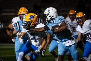 Sheridan linebacker Gauge Rodgers, left gets stiff-armed by Cheyenne East running back Keyshawn Brown during their Fryday night game at Okie Blanchard stadium in Cheyenne 