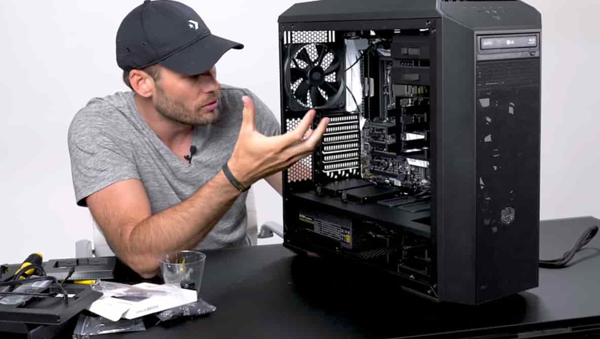 A guy showing off an all-black computer, with decently high-end parts.